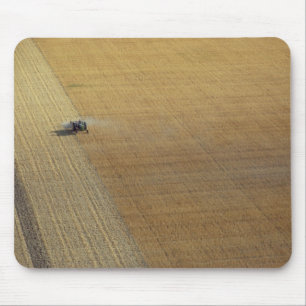 A tractor harvesting mouse pad
