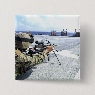 A US Marine adjusting his weapon 15 Cm Square Badge