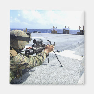 A US Marine adjusting his weapon Magnet