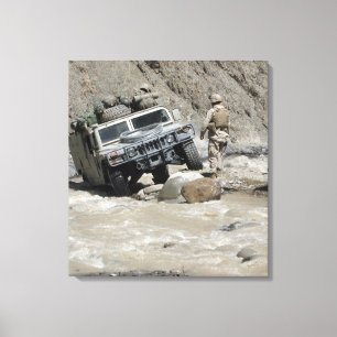 A US Marine guiding the driver of a Humvee Canvas Print