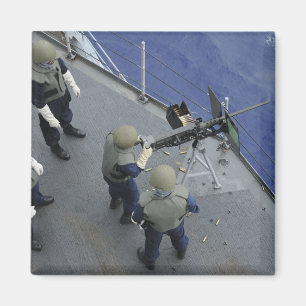 A US Sailor fires a 50-calibre M2HB Magnet