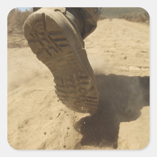 A US soldier walks along a dirt path Square Sticker (Front)