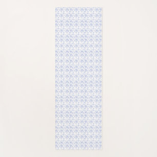 A vertical white yoga mat with an intricate blue