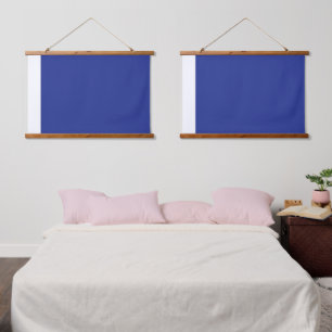 A vibrant blue backdrop with a clean white square hanging tapestry