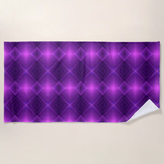 A vibrant, geometric purple pattern decorates beach towel
