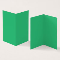 A vibrant green leaf with prominent veins and a de