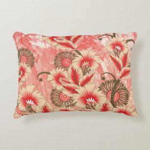 A vibrant red and peach textile design featuring f decorative cushion