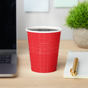 A vibrant red rose with dewdrops gently resting on paper cups