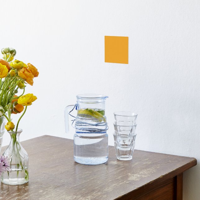 A vivid orange square surrounded by a white border foil prints (Laydown (Kitchen))