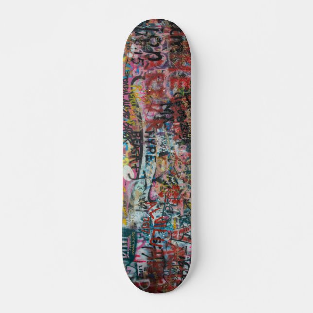 a wall full of graffiti skateboard (Front)