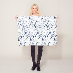 a white and blue background with a pattern fleece blanket