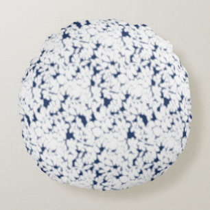 a white and blue background with a pattern round cushion