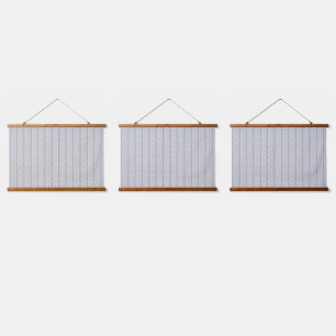 A white and grey geometric pattern fills the image hanging tapestry