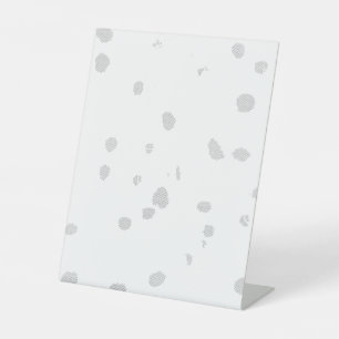 a white background with a lot of small dots pedestal sign
