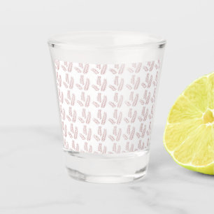 a white background with pink leaves on it shot glass