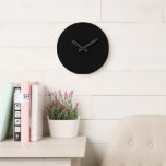 A white clock displayed prominently against a soli<br><div class="desc">The sleek and modern white clock against a bold black backdrop is the perfect addition to any contemporary space. This statement piece not only adds a touch of sophistication to your decor but also serves its primary purpose flawlessly - keeping time accurately and efficiently. Enhance your home or office with...</div>