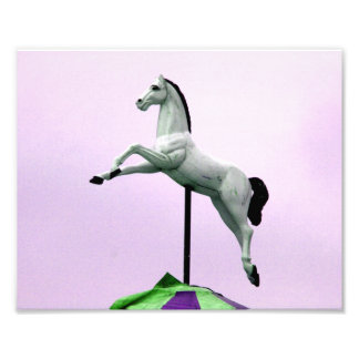 A white horse carousel statue against purple photo print