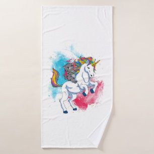 A white unicorn with rainbow tail which is ridden bath towel