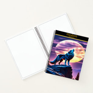 A wolf howls at a full moon on a sketchbook notebook