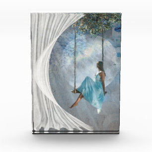 A woman in a blue dress on a swing     photo block