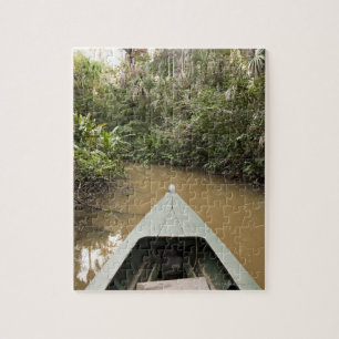 A wooden canoe made of Eucylptus tree floats in 2 Jigsaw Puzzle