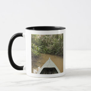 A wooden canoe made of Eucylptus tree floats in 2 Mug