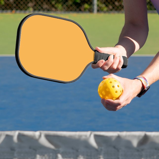 a yellow background with a black border pickleball paddle (Insitu)