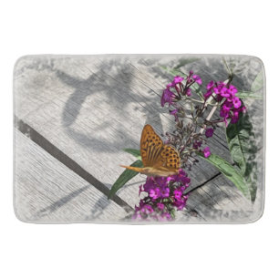 A yellow butterfly bath mat