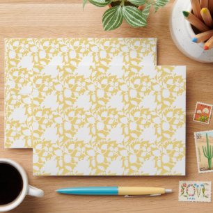 A yellow rug with a repeating motif pattern resemb envelope