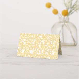 A yellow rug with a repeating motif pattern resemb place card