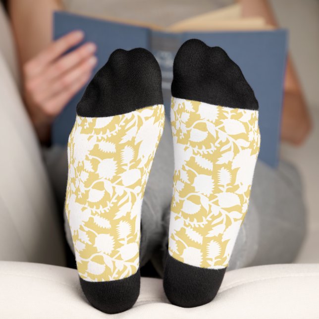 A yellow rug with a repeating motif pattern resemb socks (Bottom)