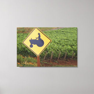 A yellow tractor crossing sign in the vineyard