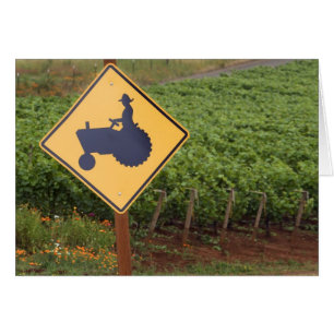 A yellow tractor crossing sign in the vineyard