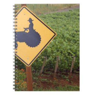 A yellow tractor crossing sign in the vineyard notebook