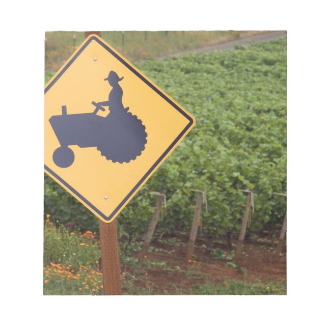 A yellow tractor crossing sign in the vineyard notepad (Front)