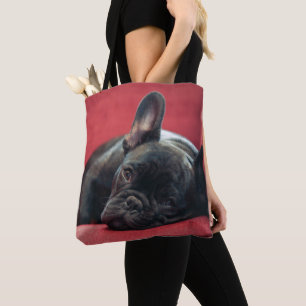 A Young French Bulldog Lying On A Couch Tote Bag