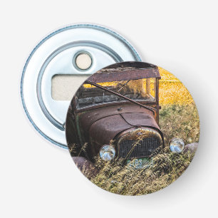 Abandoned old car in tall grass bottle opener