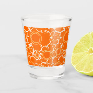 ABSTRACT FLORAL PATTERN IN ORANGE SHOT GLASS