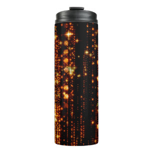 Abstract gold rain with bright particles with flar thermal tumbler