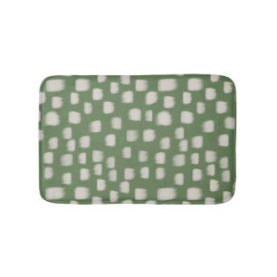 Abstract ivory brush strokes on green bath mat