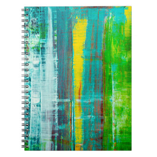 Abstract painted canvas. Oil paints on a palette.  Notebook