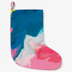 Abstract pink and turquoise paint background with small christmas stocking