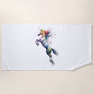 Abstract rainbow coloured watercolor of an unicorn beach towel