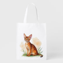 Abyssinian cat surrounded by soft colours and gree