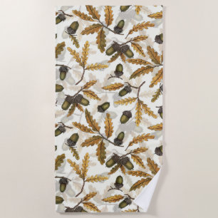 Acorns and oak leaves on off white beach towel
