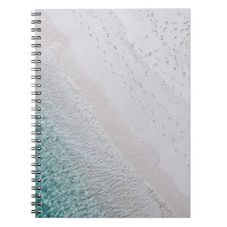 AERIAL PHOTOGRAPHY OF WHITE SAND SEASHORE AND GREE NOTEBOOK