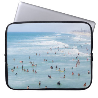 AERIAL VIEW OF GROUP OF PEOPLE SWIMMING ON BEACH LAPTOP SLEEVE