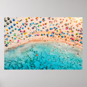 Aerial view of sandy beach with colourful umbrella poster