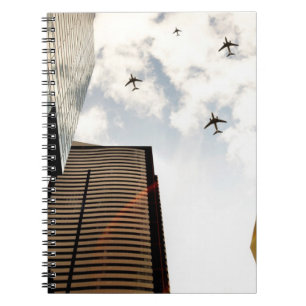 Aeroplanes flying over buildings spiral notebook