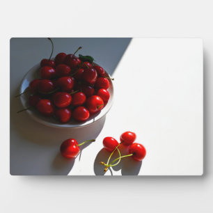 Aesthetic still life with ripe cherries on a white plaque